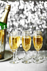 Glasses of champagne on bright background
