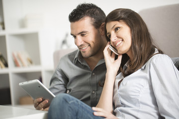 young couple using tablet pc at home
