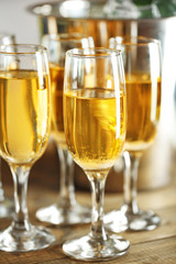 Glasses of champagne on bright background