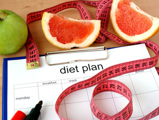 Paper with diet plan and grapefruit