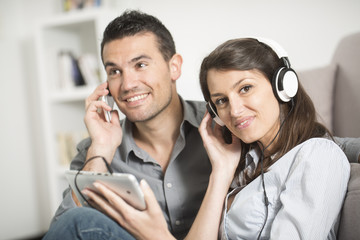 young couple using tablet pc at home