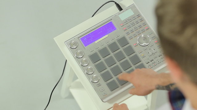 Close up of DJ mixing music on a panel of the midi controller