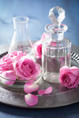 Obraz na płótnie Canvas aromatherapy set with rose flowers and flasks