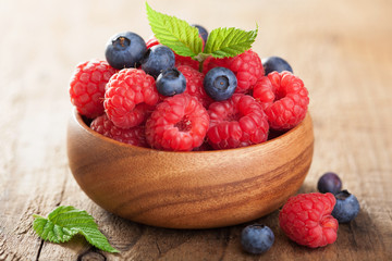 fresh berries raspberry blueberry in wooden bowl