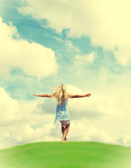 girl stands on a hill outstretched hand