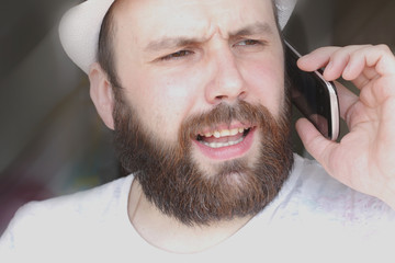 Obraz premium portrait of a bearded man smile leisure talking on the phone