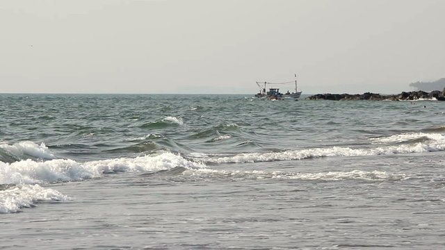 commercial fishing boat on the horizon