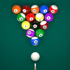 Placed billiard balls on table with cue on green table