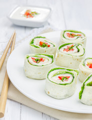 Tortilla roll with soft cheese, chicken ham, and vegetable