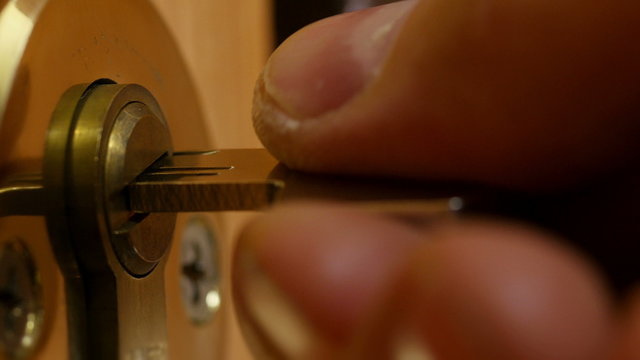  Key sliding into lock and locking\ unlocking door.