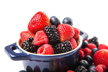 Strawberry, blueberry, blackberry and raspberry in a blue pot