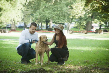 Obraz premium Young couple and dog