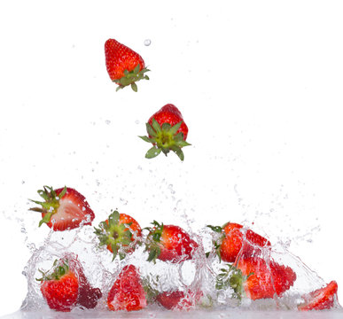Strawberries in water splash on white backround