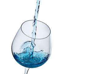 Water poured into a glass on a white background