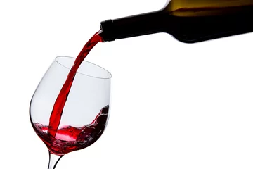 Fotobehang wine is poured into a glass on a white background © deviddo