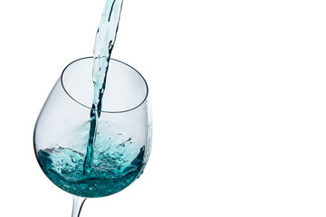 Water poured into a glass on a white background