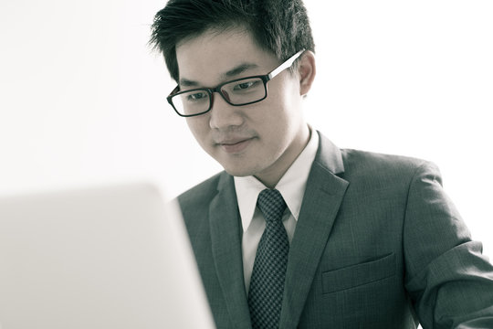 Handsome businessman working with laptop