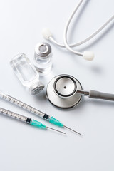 Medical equipment : stethoscope ampoules and syringe on white ba