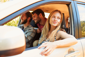 Group Of Friends In Car On Road Trip Together
