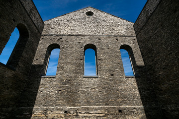 Stone Wall of Ancient Church Ruins with Gothic Windows