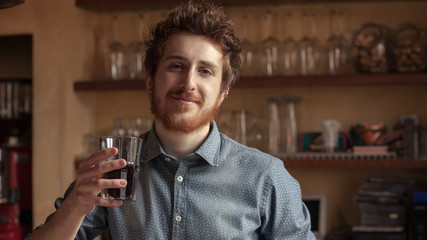 Hipster man drinking a glass of coke