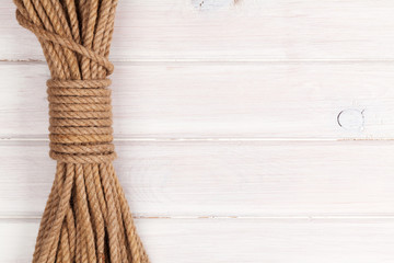 Wooden background with marine rope