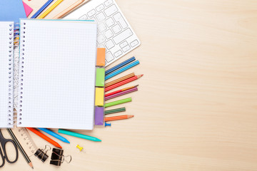 Blank notepad over school and office supplies