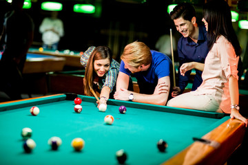 Young people playing billiard