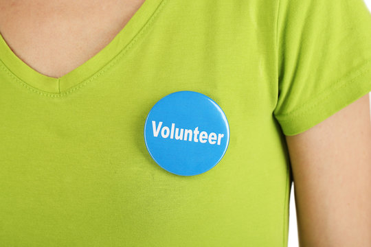 Round volunteer button on shirt of girl