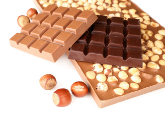 Black and milk chocolate bars with hazelnuts isolated on white