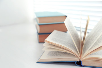 Books on white windowsill, close up