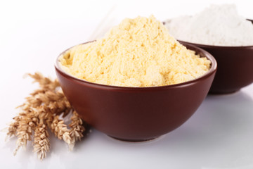 Flour in bowls with wheat ears, closeup