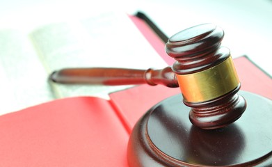 Legal concept with gavel against red background