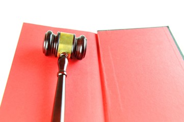 Justice concept with gavel against red book