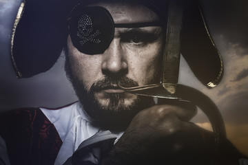pirate with hat and eye patch holding a sword - obrazy, fototapety, plakaty