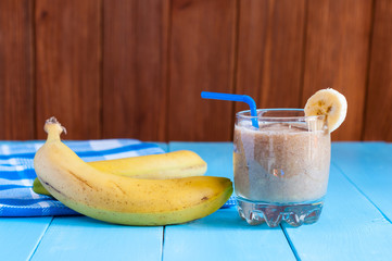 Healthy homemade chocolate banana smoothie in glass and fresh