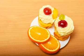 Fototapeta na wymiar Gourmet cream cake cookie and orange on plate