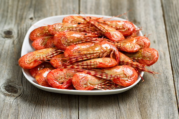 Fresh Steamed Shrimp in White Plate with rustic wood