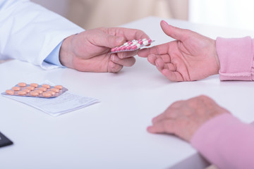 Doctor's hands giving patient medicament