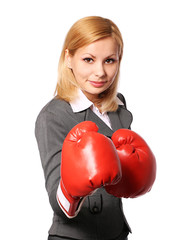 Business woman with boxing gloves isolated on white