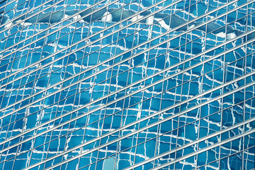Reflection in blue glass wall of an modern office building