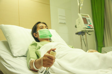 Hand pressing emergency nurse call button - Stock image