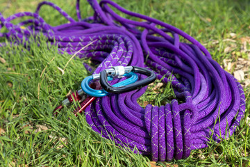 Purple climbing rope on green grass