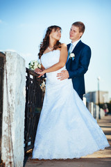 Fototapeta premium Bride and Groom at wedding Day walking Outdoors on spring nature
