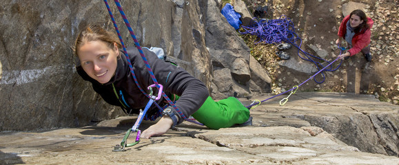Pair of female climbers assault the rock wall