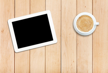 Tablet and coffee on a wooden table