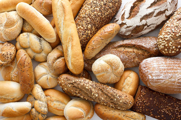 Many mixed breads and rolls shot from above. - Powered by Adobe