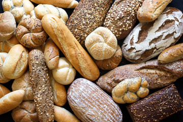 Many mixed breads and rolls shot from above. - obrazy, fototapety, plakaty