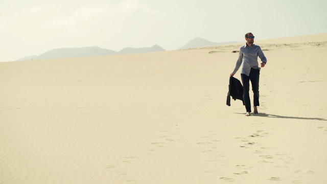 Lost businessman walking through desert
