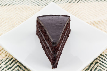 Chocolate cake slice on white plates.